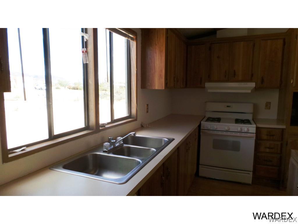 171 South Hano Road Golden Valley, AZ 86413 - Photo 6 of 20 a kitchen with a sink stove and cabinets