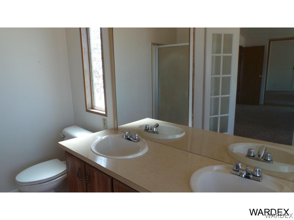 171 South Hano Road Golden Valley, AZ 86413 - Photo 10 of 20 a bathroom with a sink toilet and mirror