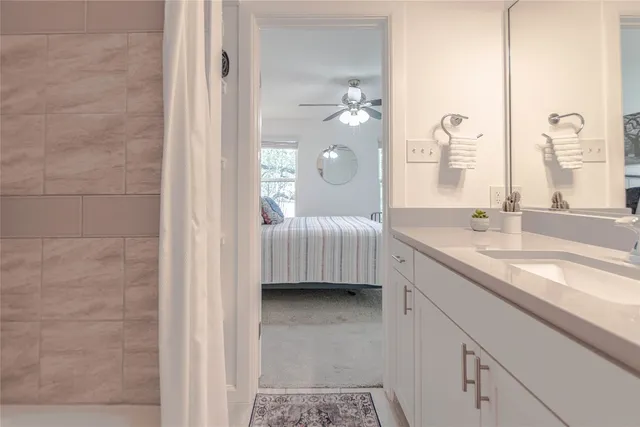 a en suite bathroom with a double vanity sink a mirror and a shower