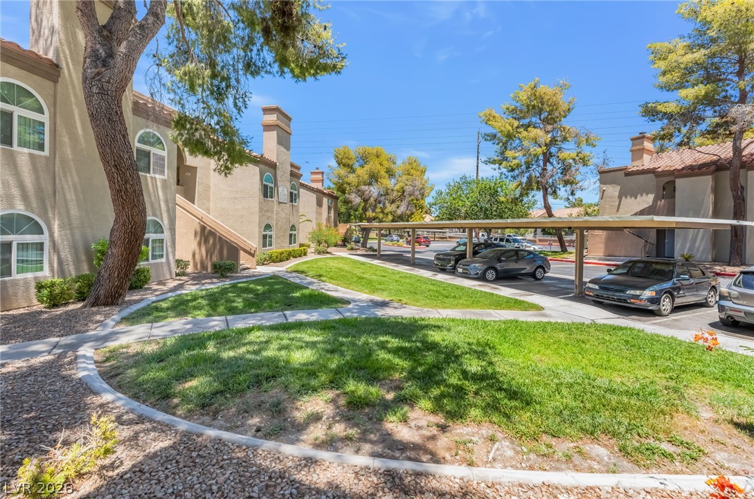 3145 East Flamingo Road, Unit 1092 Las Vegas, NV 89121 - Photo 30 of 33 Manicured green spaces define the entrance to this inviting multifamily residence with convenient covered parking.