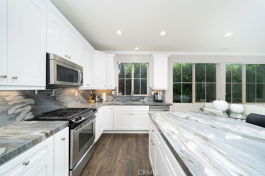 60 Visionary Irvine, CA 92618 - Photo 11 of 30 a kitchen with a stove a sink and a granite counter top