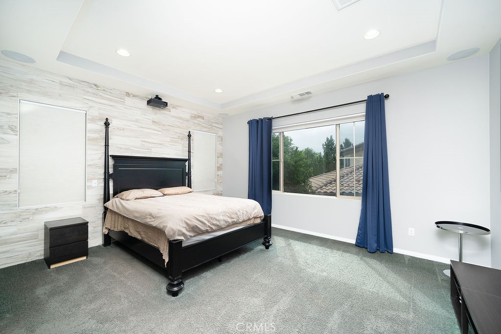 60 Visionary Irvine, CA 92618 - Photo 16 of 30 a spacious bedroom with a large bed and a fireplace