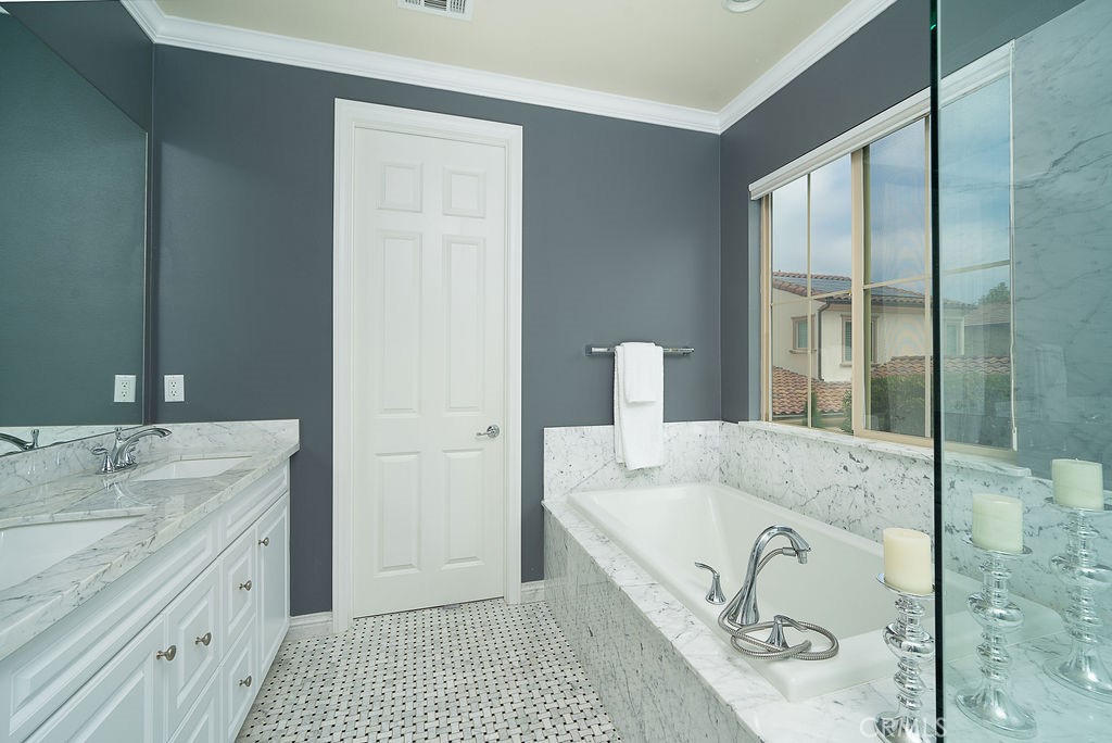 60 Visionary Irvine, CA 92618 - Photo 19 of 30 a bathroom with a tub sink and mirror
