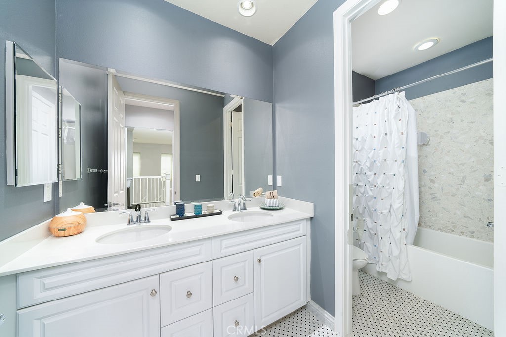 60 Visionary Irvine, CA 92618 - Photo 22 of 30 a bathroom with double vanity sinks a large mirror and a bathtub