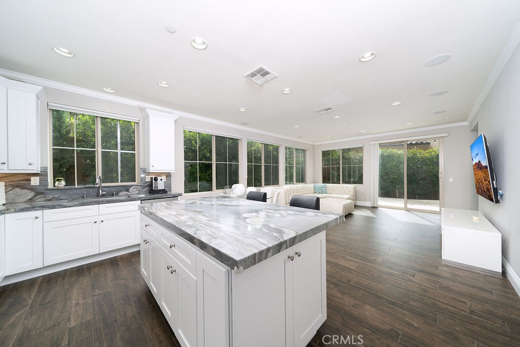60 Visionary Irvine, CA 92618 - Photo 6 of 30 a open kitchen with granite countertop a sink and dishwasher with wooden floor