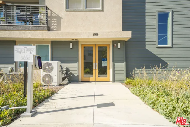 a large white bathroom with a granite countertop sink a mirror and a bathtub