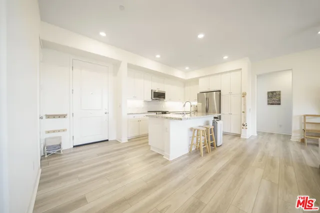 a living room with furniture and kitchen view