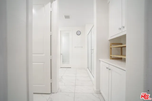 a view of a kitchen with wooden floor and a sink
