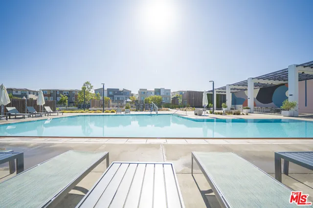 a view of swimming pool with outdoor seating and yard