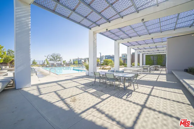 a view of a swimming pool with a lounge chair