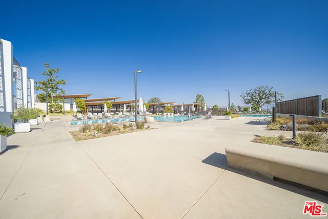 a swimming pool with outdoor seating and yard