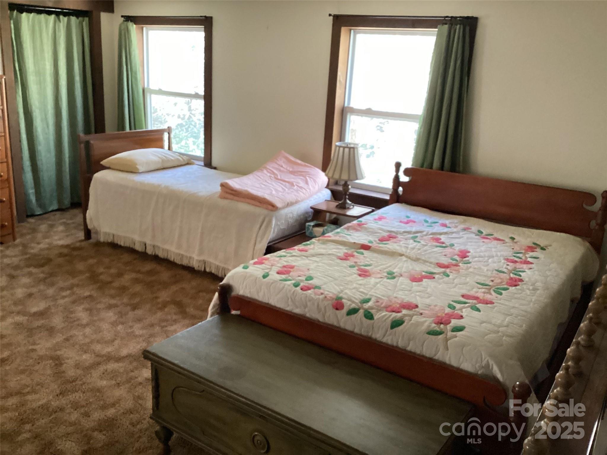 4700 West Buffalo Road Robbinsville, NC 28771 - Photo 18 of 25 a bedroom with two beds and next to a window