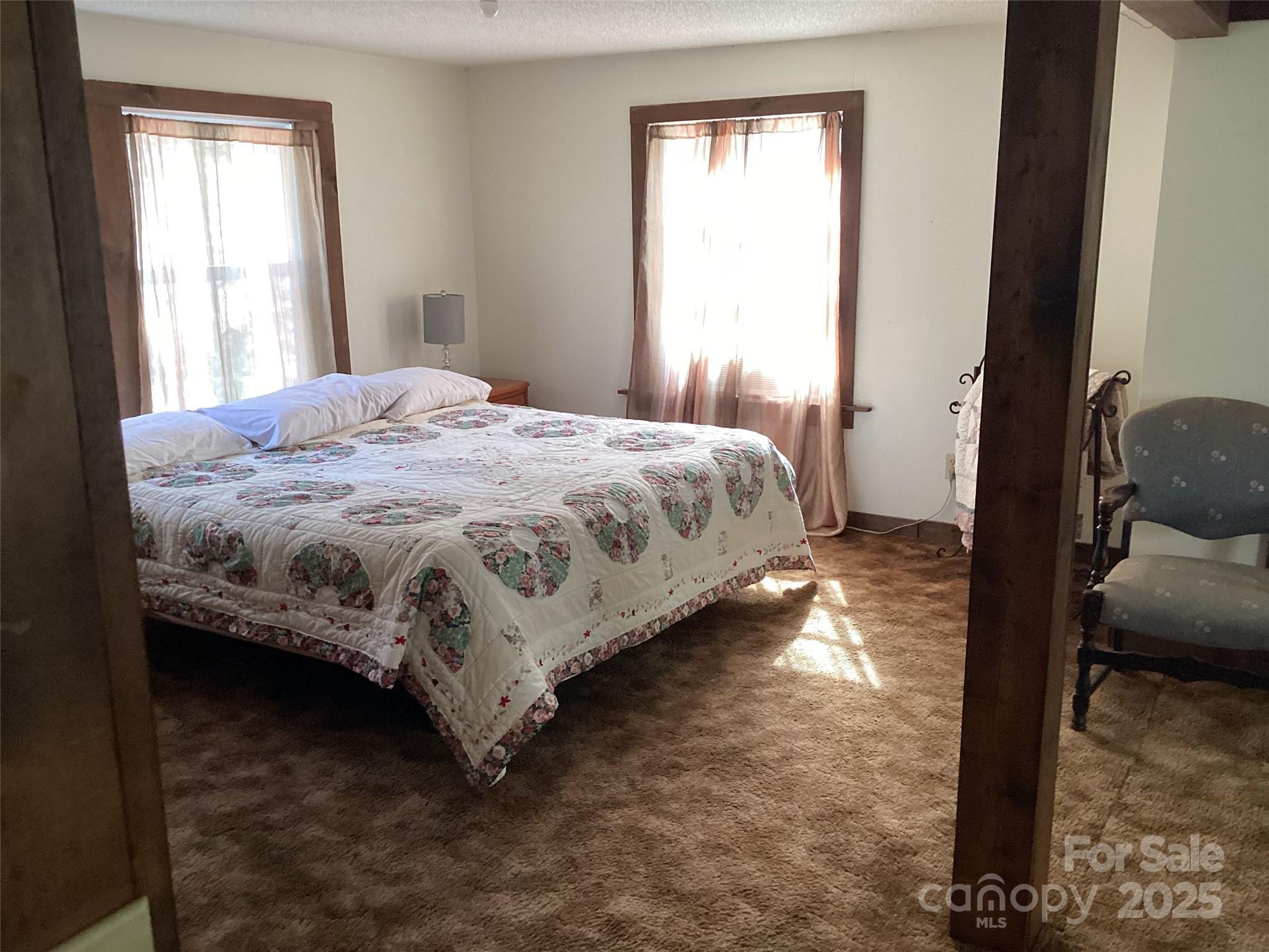 4700 West Buffalo Road Robbinsville, NC 28771 - Photo 19 of 25 a bedroom with a bed and window