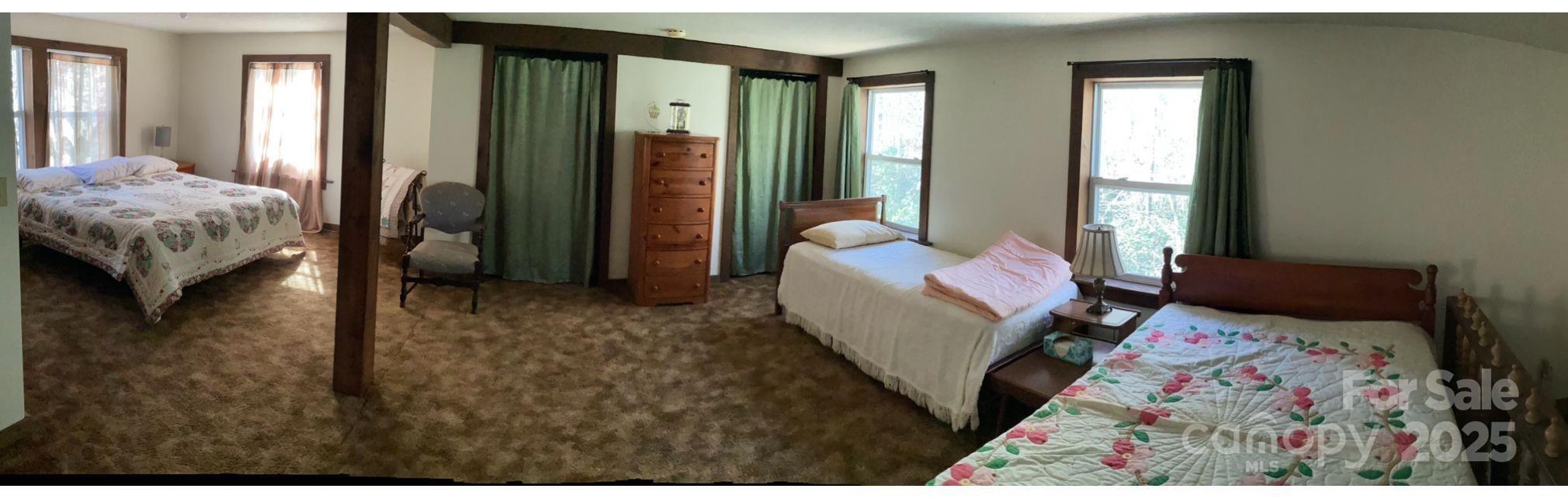 4700 West Buffalo Road Robbinsville, NC 28771 - Photo 23 of 25 a bed sitting in a bedroom next to a window