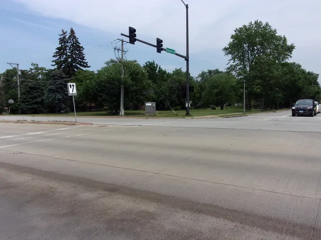 a backyard of a house with lots of green space and trees