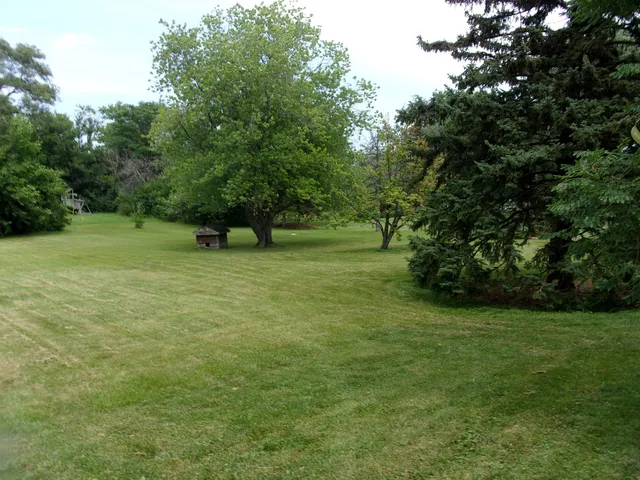 a backyard of a house with barbeque oven and outdoor seating