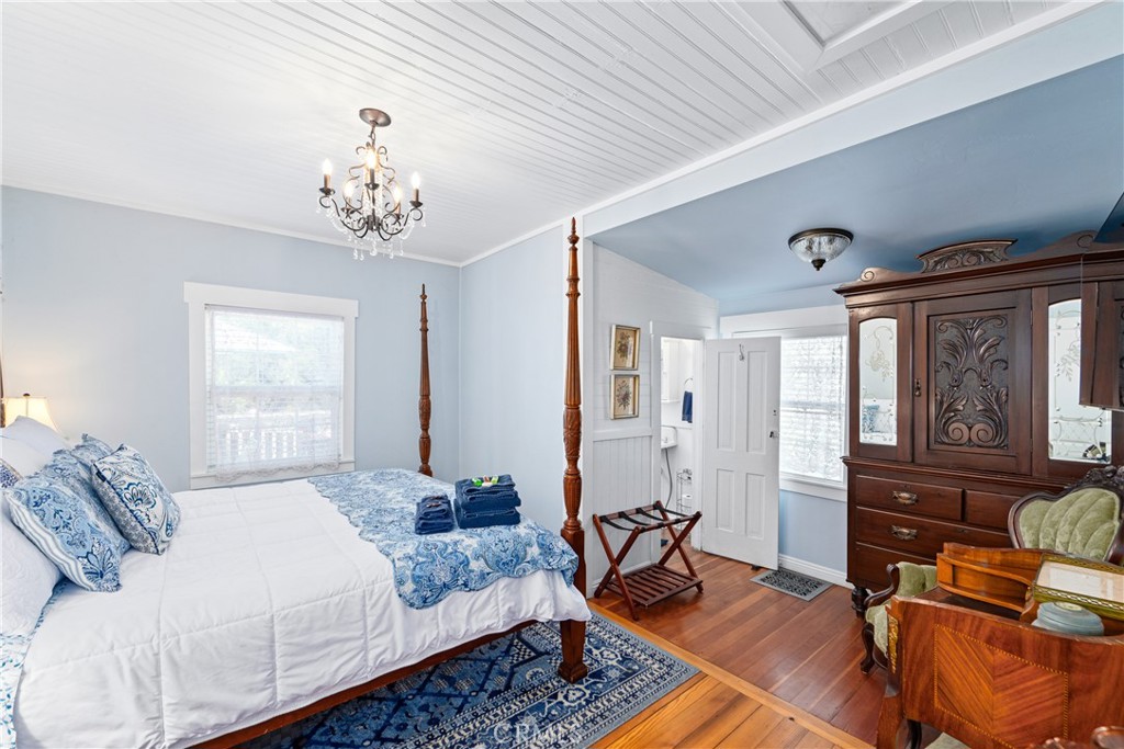 2013 3rd Street Julian, CA 92036 - Photo 13 of 32 a bedroom with a bed dresser and wooden floor