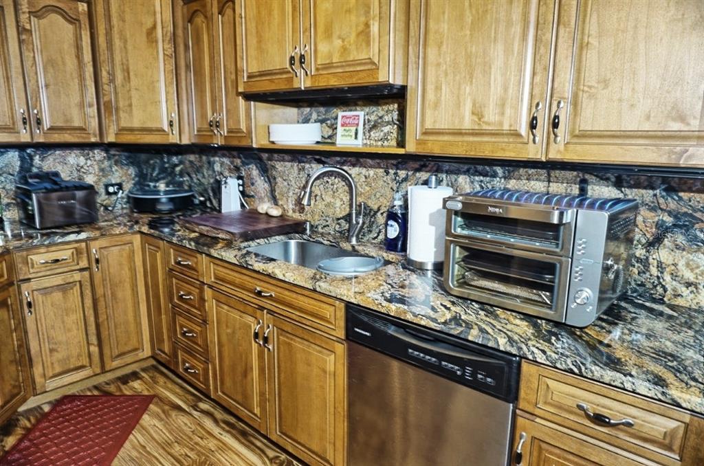 1873 Mazo Manor Road, Unit 5 Lutz, FL 33558 - Photo 15 of 41 a kitchen with stainless steel appliances granite countertop a sink a stove and cabinets