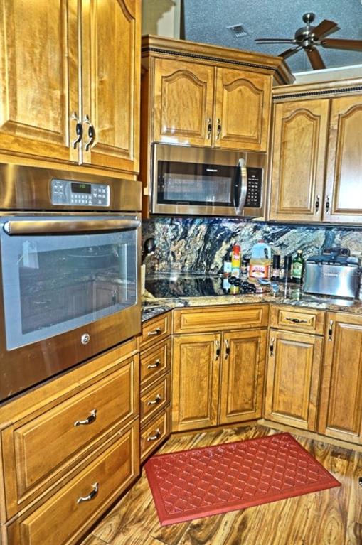 1873 Mazo Manor Road, Unit 5 Lutz, FL 33558 - Photo 16 of 41 a view of a kitchen with stainless steel appliances granite countertop a sink and cabinets