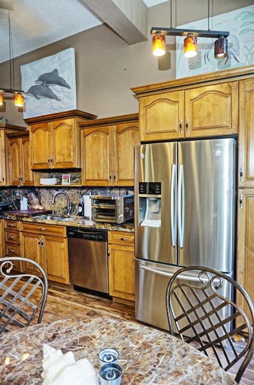 1873 Mazo Manor Road, Unit 5 Lutz, FL 33558 - Photo 18 of 41 a kitchen with stainless steel appliances granite countertop a sink stove and refrigerator