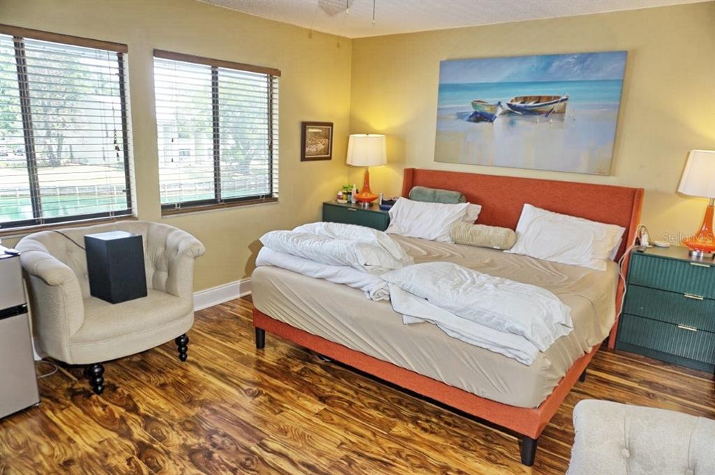 1873 Mazo Manor Road, Unit 5 Lutz, FL 33558 - Photo 19 of 41 a bedroom with a bed and wooden floor