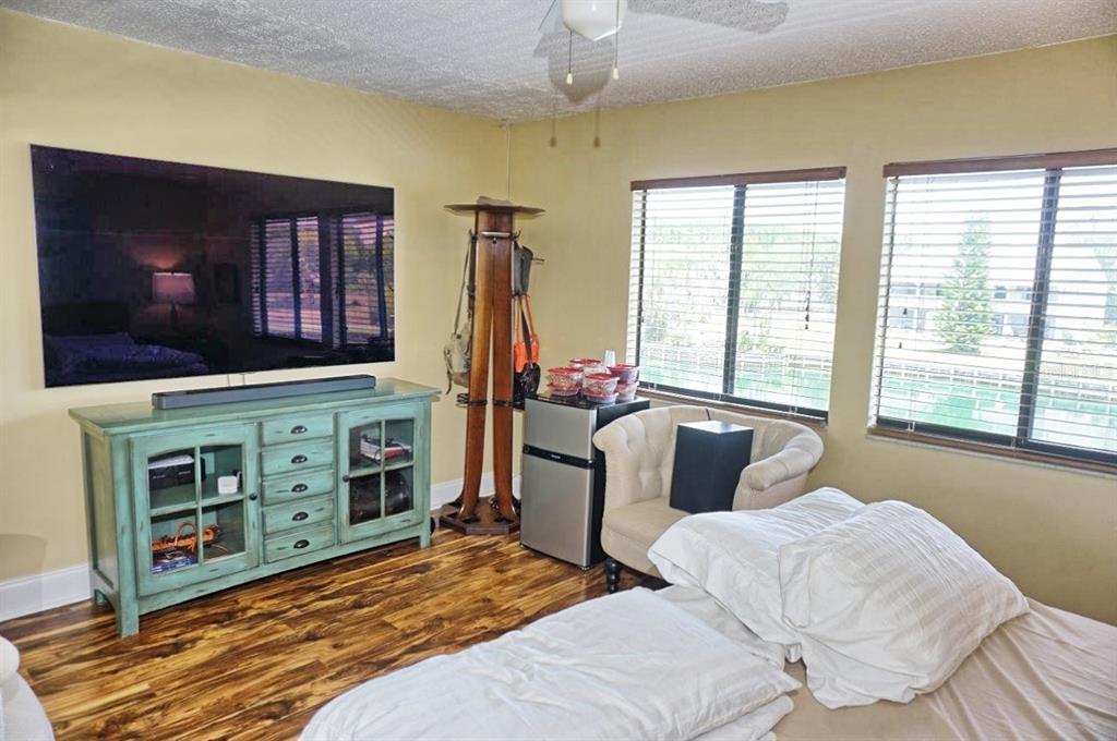 1873 Mazo Manor Road, Unit 5 Lutz, FL 33558 - Photo 20 of 41 a bedroom with furniture and a flat screen tv