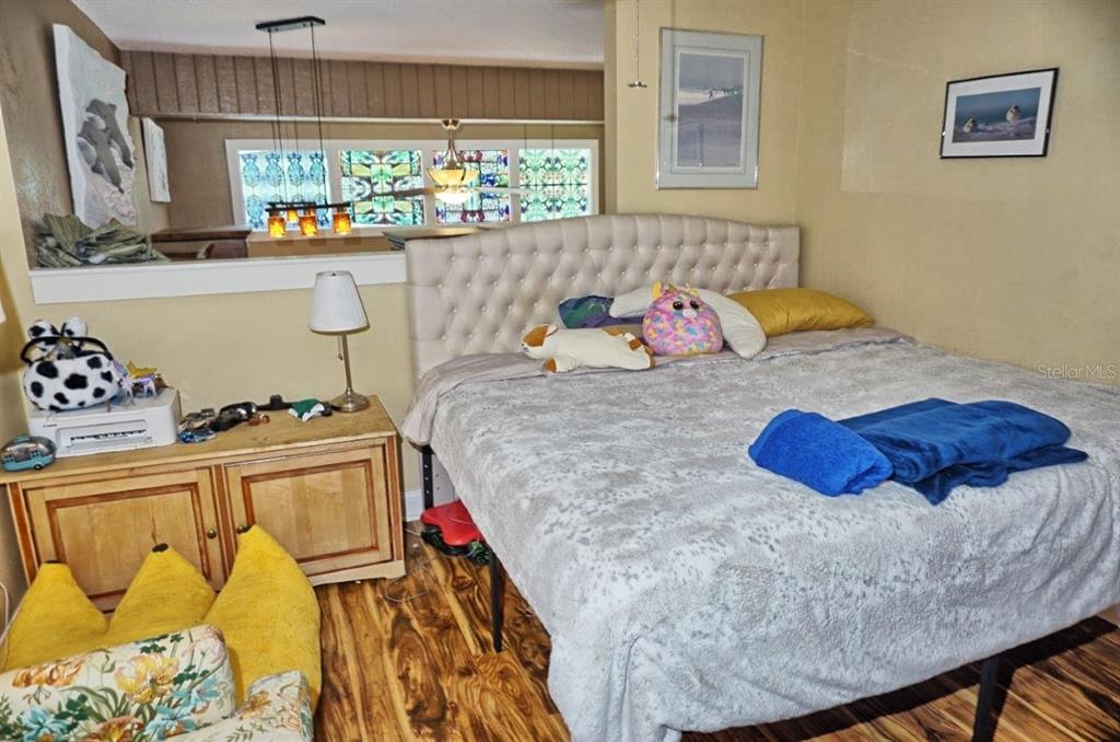 1873 Mazo Manor Road, Unit 5 Lutz, FL 33558 - Photo 28 of 41 a bedroom with a bed and a window