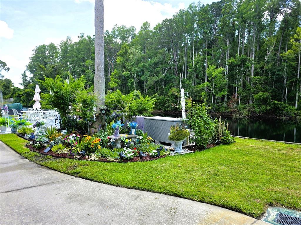 1873 Mazo Manor Road, Unit 5 Lutz, FL 33558 - Photo 37 of 41 a view of a chair and tables in the garden