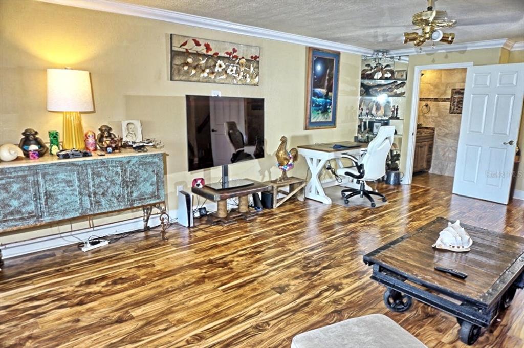 1873 Mazo Manor Road, Unit 5 Lutz, FL 33558 - Photo 4 of 41 a living room with furniture and a table