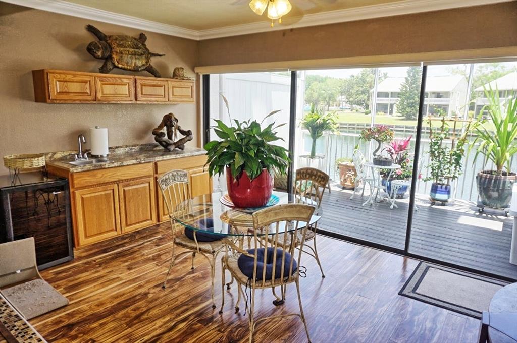1873 Mazo Manor Road, Unit 5 Lutz, FL 33558 - Photo 7 of 41 a view of a dining room with furniture window and wooden floor
