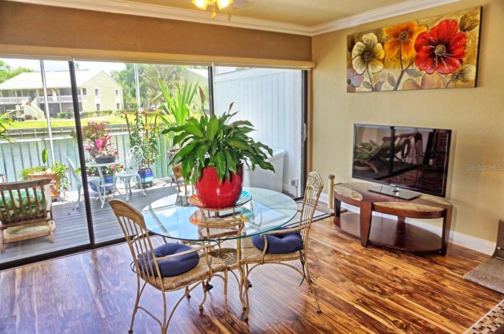 1873 Mazo Manor Road, Unit 5 Lutz, FL 33558 - Photo 8 of 41 a living room with furniture and a potted plant