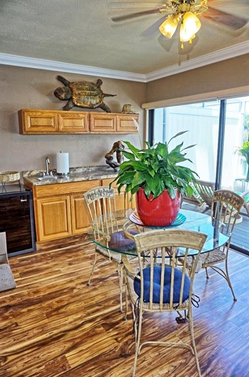 1873 Mazo Manor Road, Unit 5 Lutz, FL 33558 - Photo 9 of 41 a dining room with furniture potted plants and wooden floor