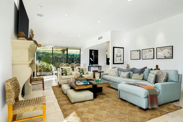 a living room with fireplace furniture and a flat screen tv