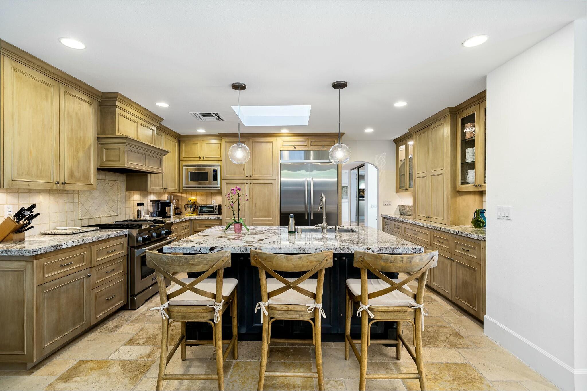 7 Princeton Drive Rancho Mirage, CA 92270 - Photo 12 of 39 a kitchen with stainless steel appliances kitchen island granite countertop a sink and cabinets