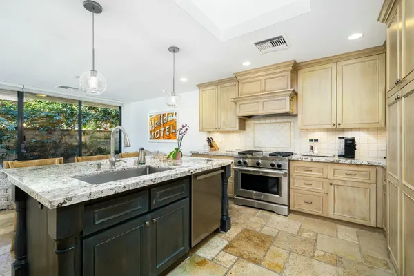 a kitchen with a sink stove and cabinets