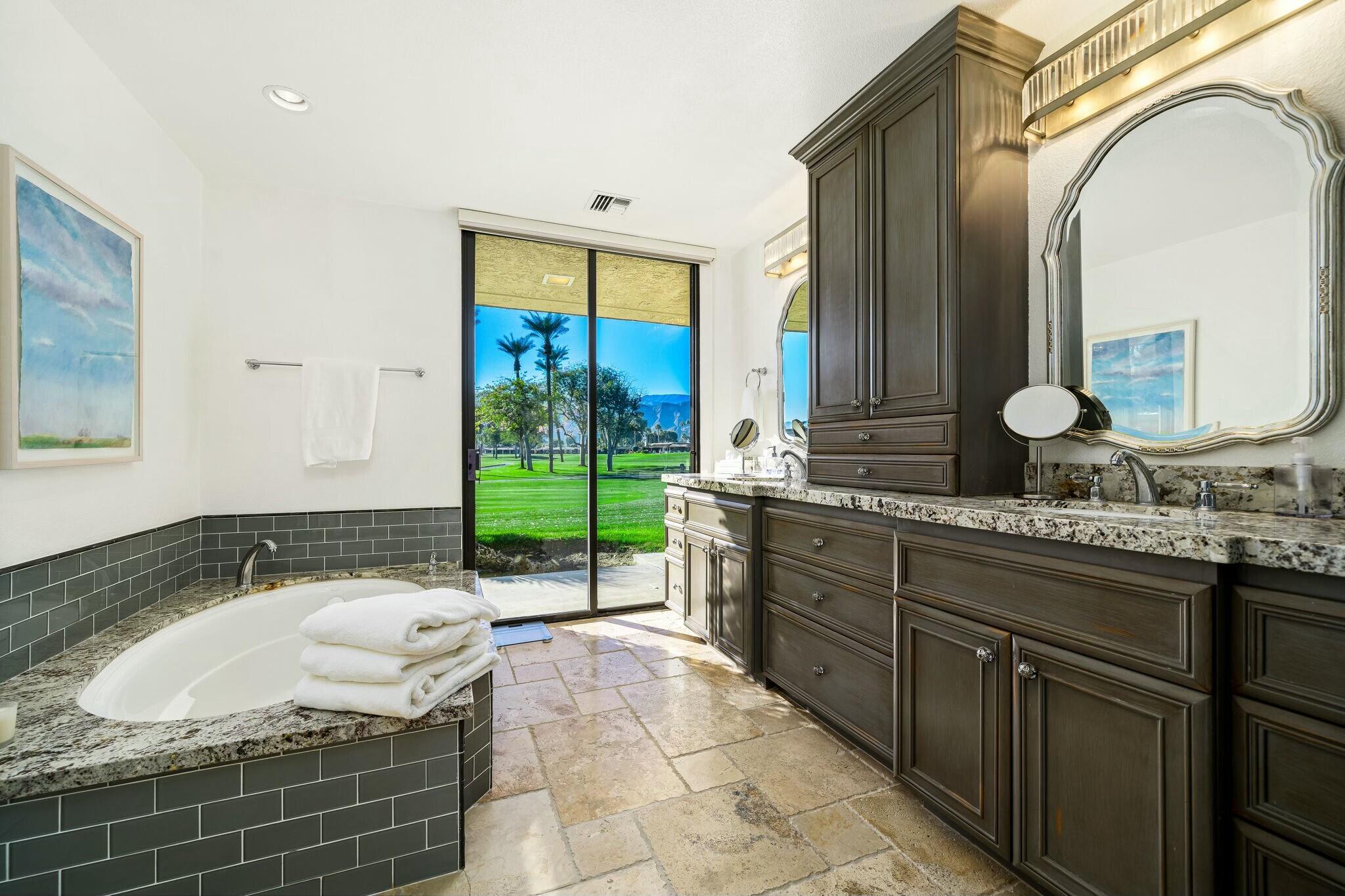 7 Princeton Drive Rancho Mirage, CA 92270 - Photo 20 of 39 a spacious bathroom with a tub sink and mirror