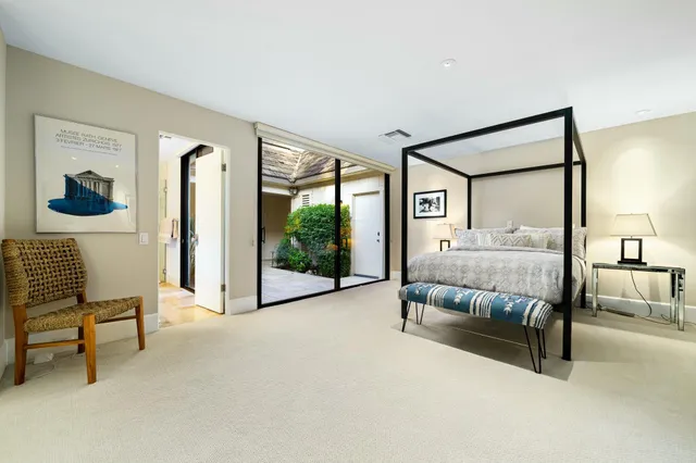 a bedroom with a bed and a view of en suite bathroom