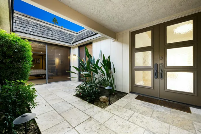 a building with potted plants in front of it