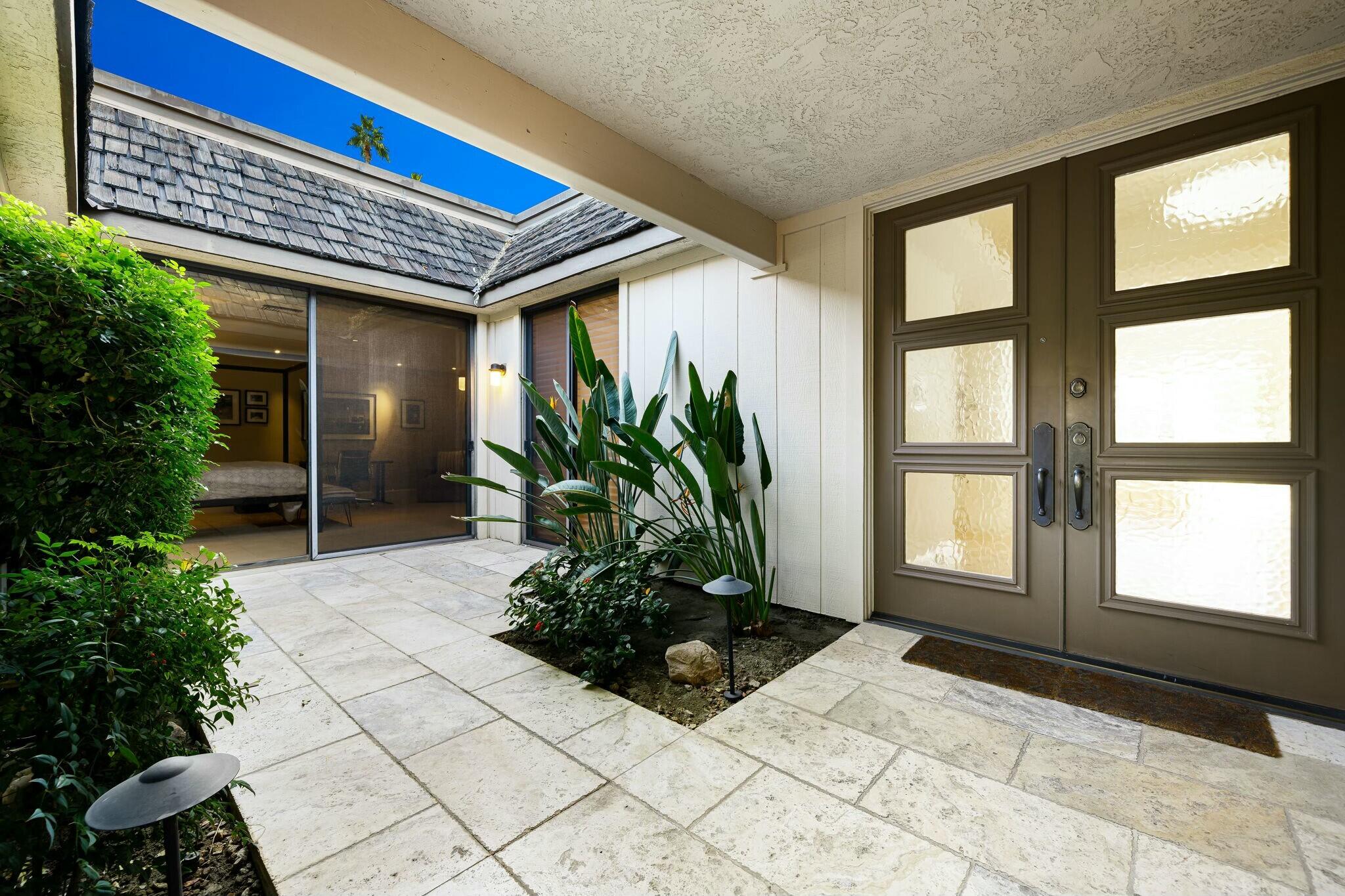 7 Princeton Drive Rancho Mirage, CA 92270 - Photo 25 of 39 a building with potted plants in front of it