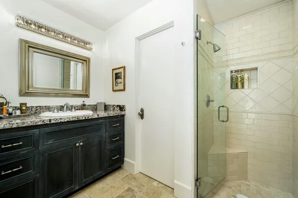 a bathroom with a granite countertop sink mirror and double