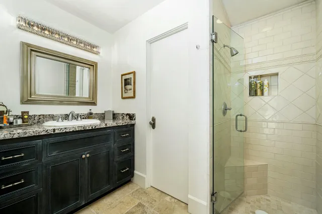 a bathroom with a granite countertop sink mirror and double