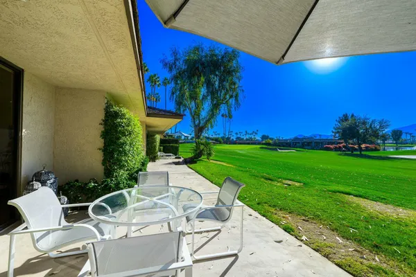 a view of yard with seating area and trees around