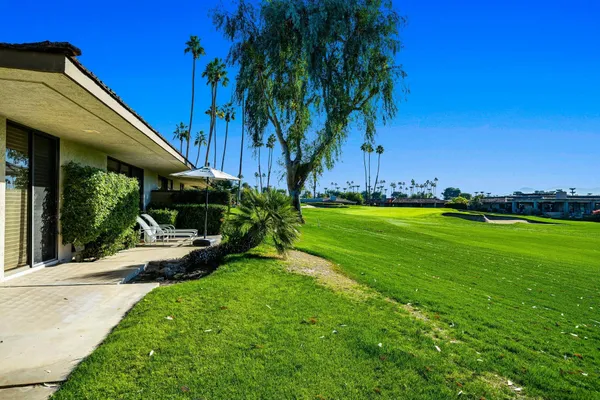 a view of a house with backyard porch and sitting area