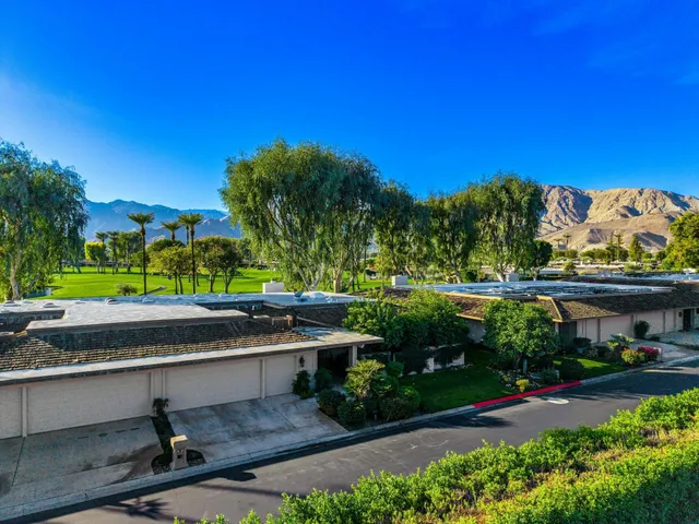 a view of house with garden space and deck
