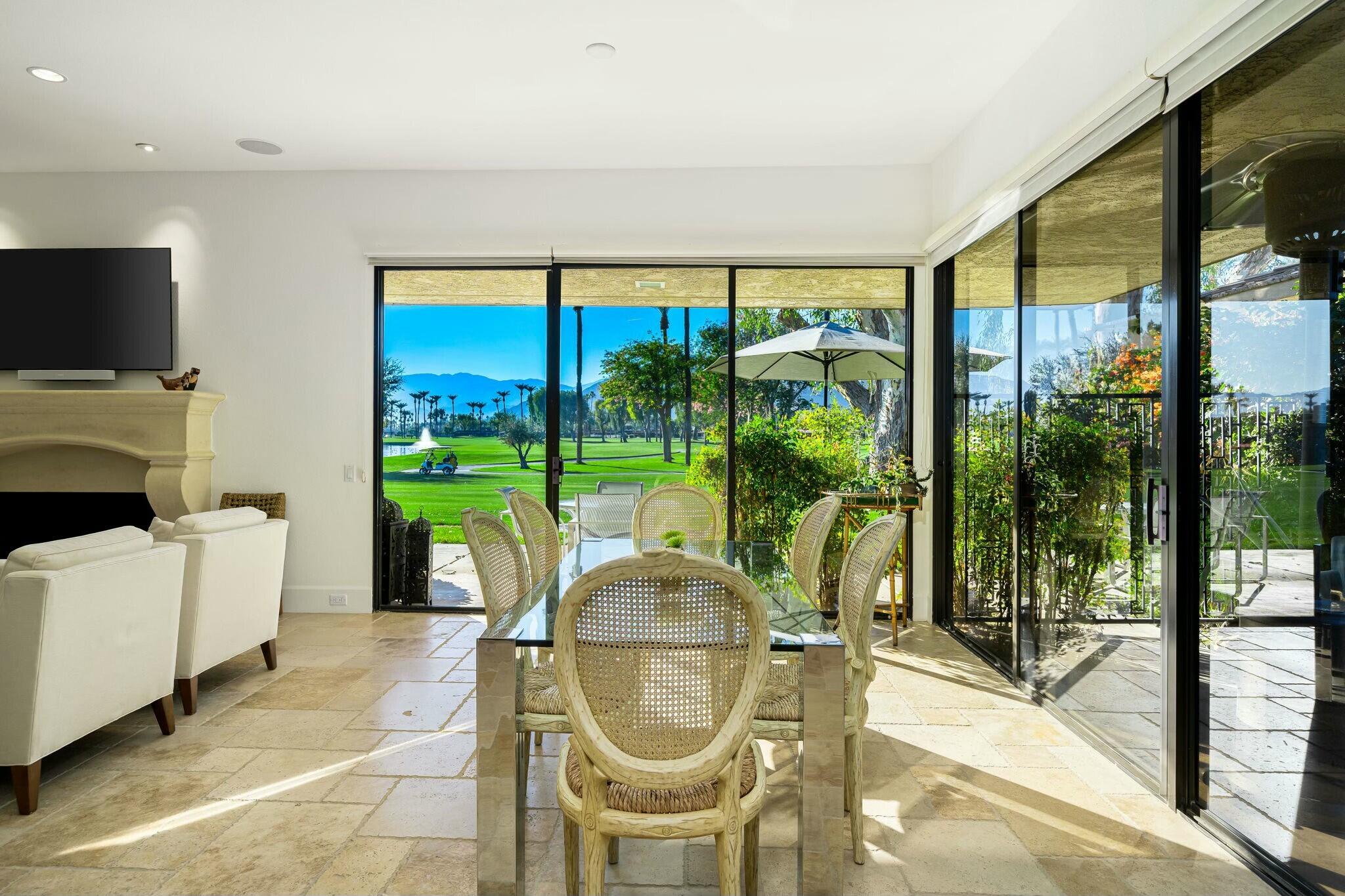 7 Princeton Drive Rancho Mirage, CA 92270 - Photo 6 of 39 a living room with a floor to ceiling window and a table