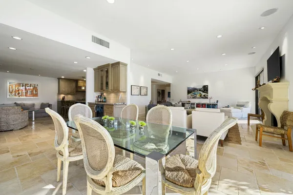 a living room with furniture a dining table and kitchen view