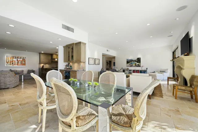 a living room with furniture a dining table and kitchen view