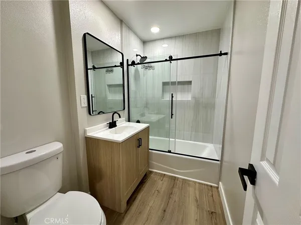 a bathroom with a sink mirror vanity and toilet