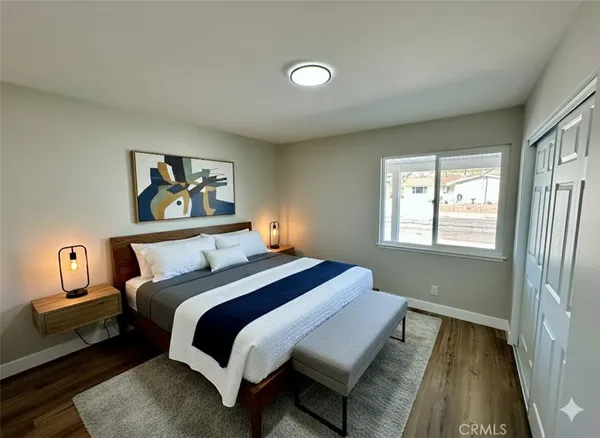 a bedroom with a bed and a painting on the wall