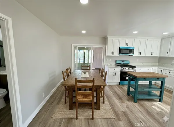 a dining room with furniture and wooden floor